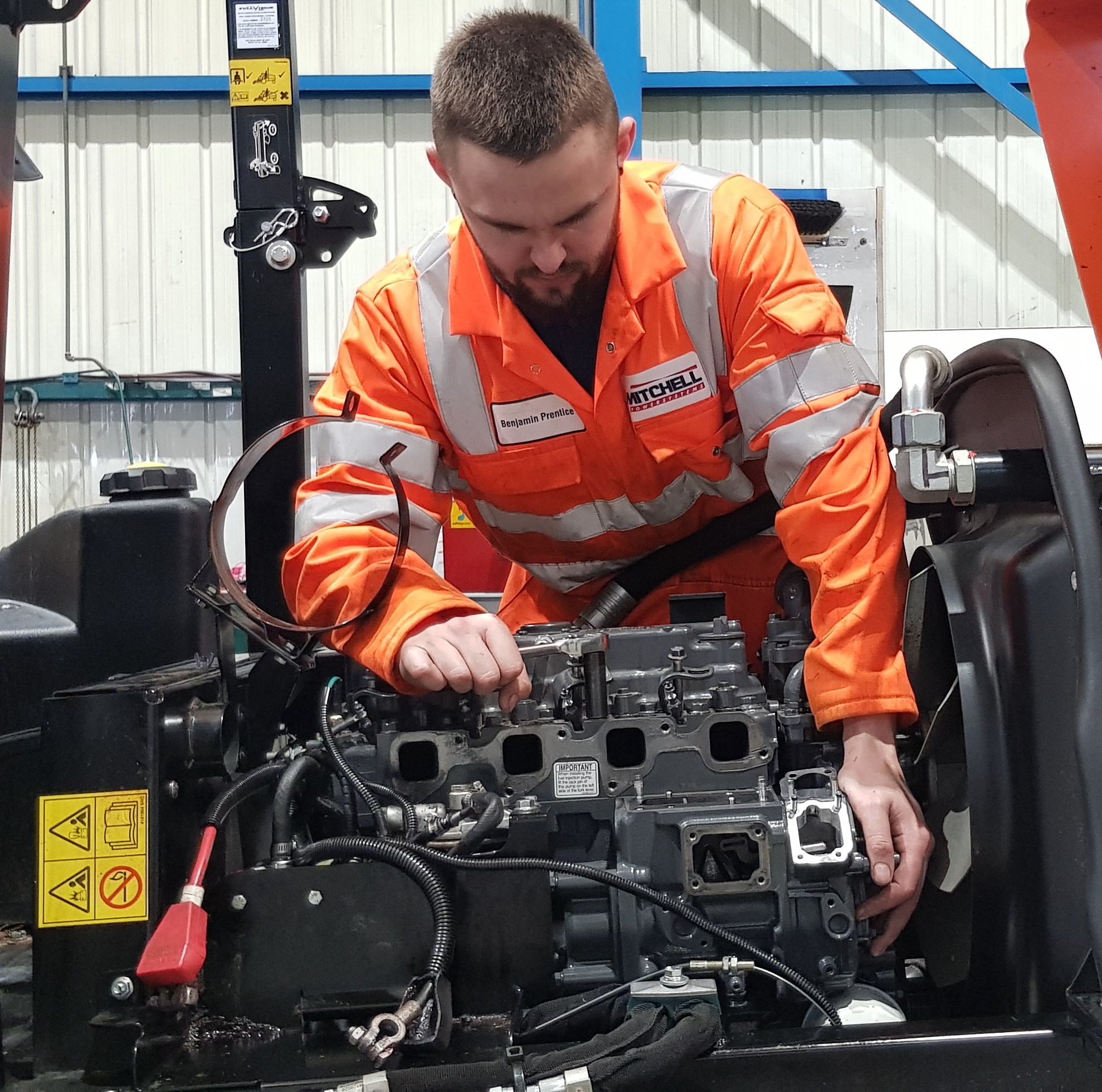 Kubota Engine Service image showing a person working with Kubota engine equipment in a setting