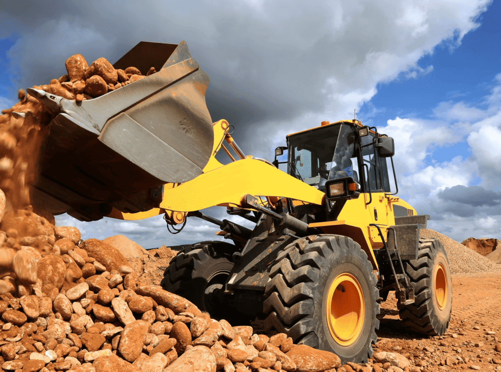 Yellow construction vehicle moving rubble